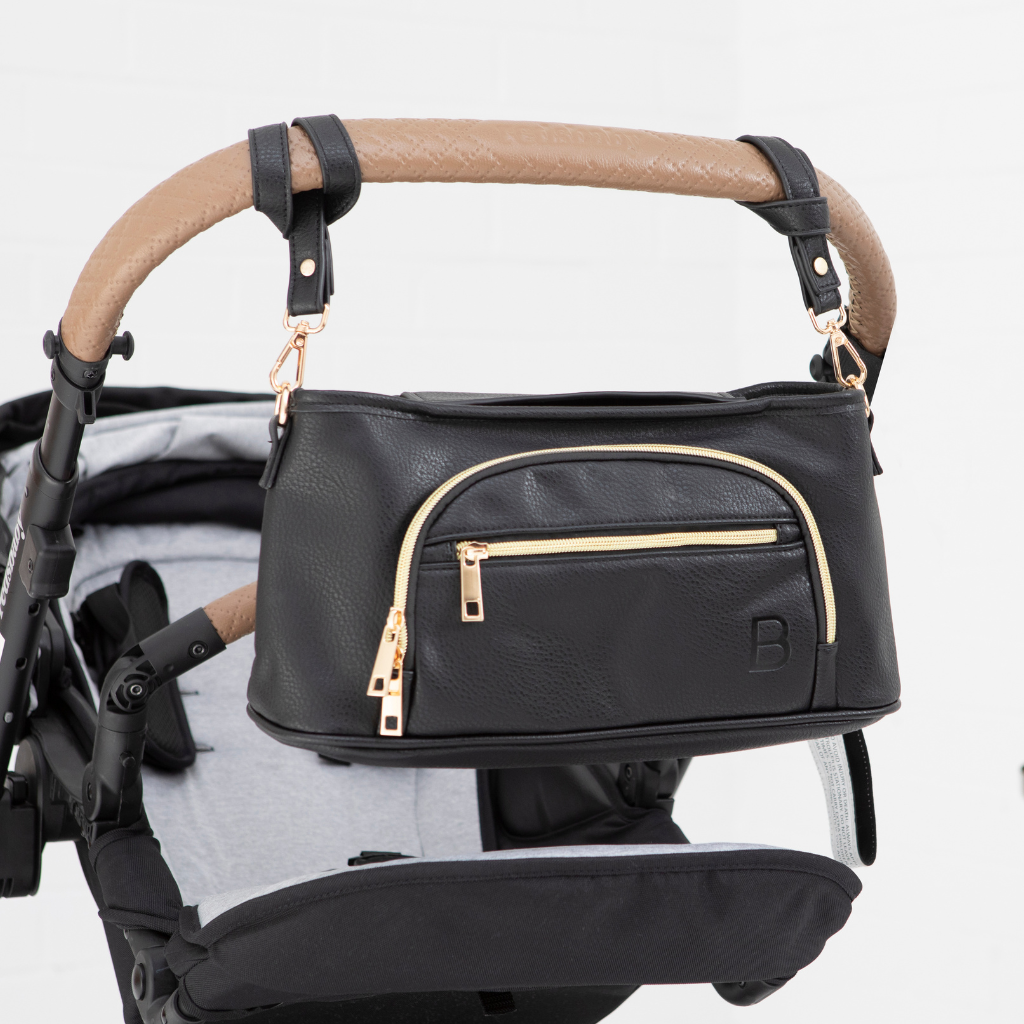 The Sofia universal pram caddy in black vegan leather By Bambino Bagz - The best pram caddy to organise your baby essentials. Fits any pram and converts into a cross body nappy bag in seconds