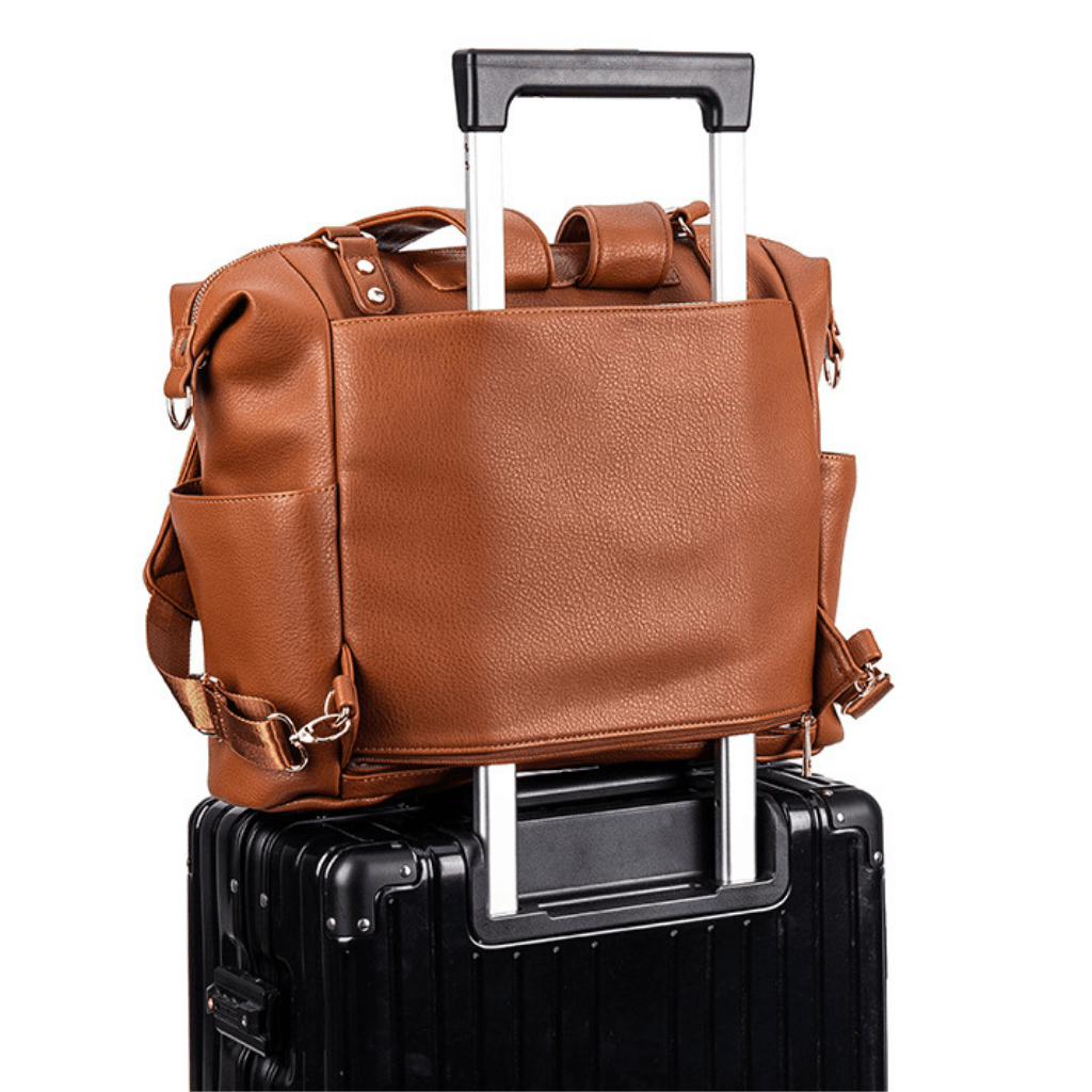 The perfect travel bag that slides over your hand luggage  the Sofia nappy bag baby bag in Tan vegan leather ideal for travelling with your family